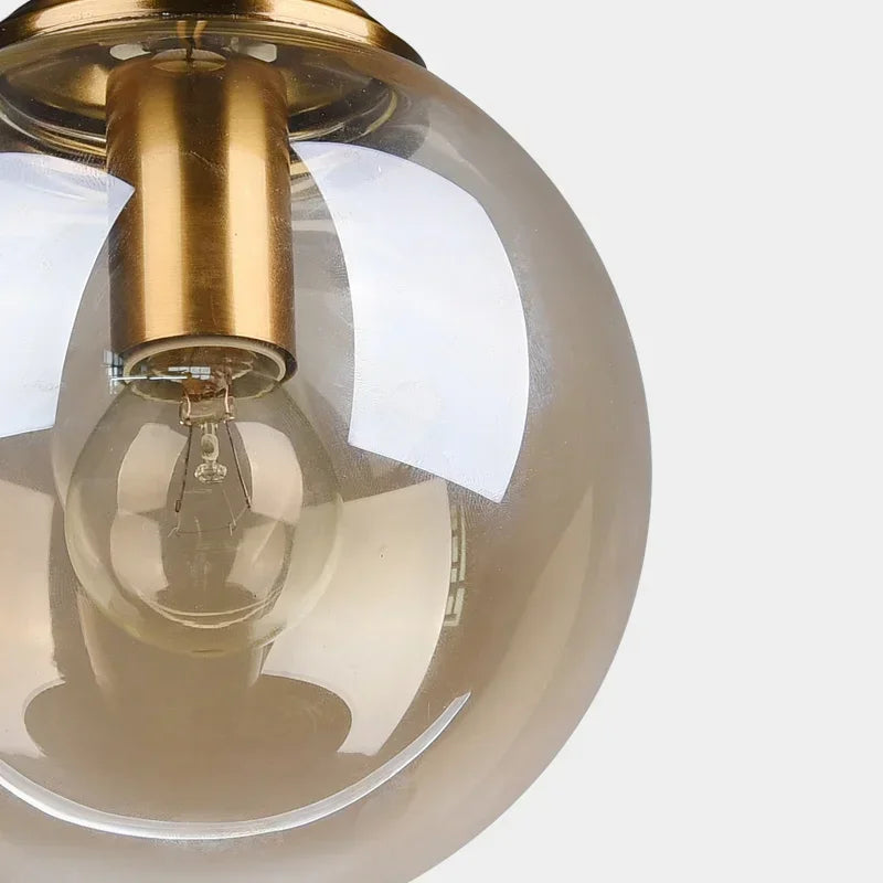 Éclat — Suspension design en verre ambré, lumière chaleureuse & élégante