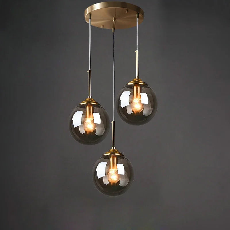 Éclat — Suspension design en verre ambré, lumière chaleureuse & élégante